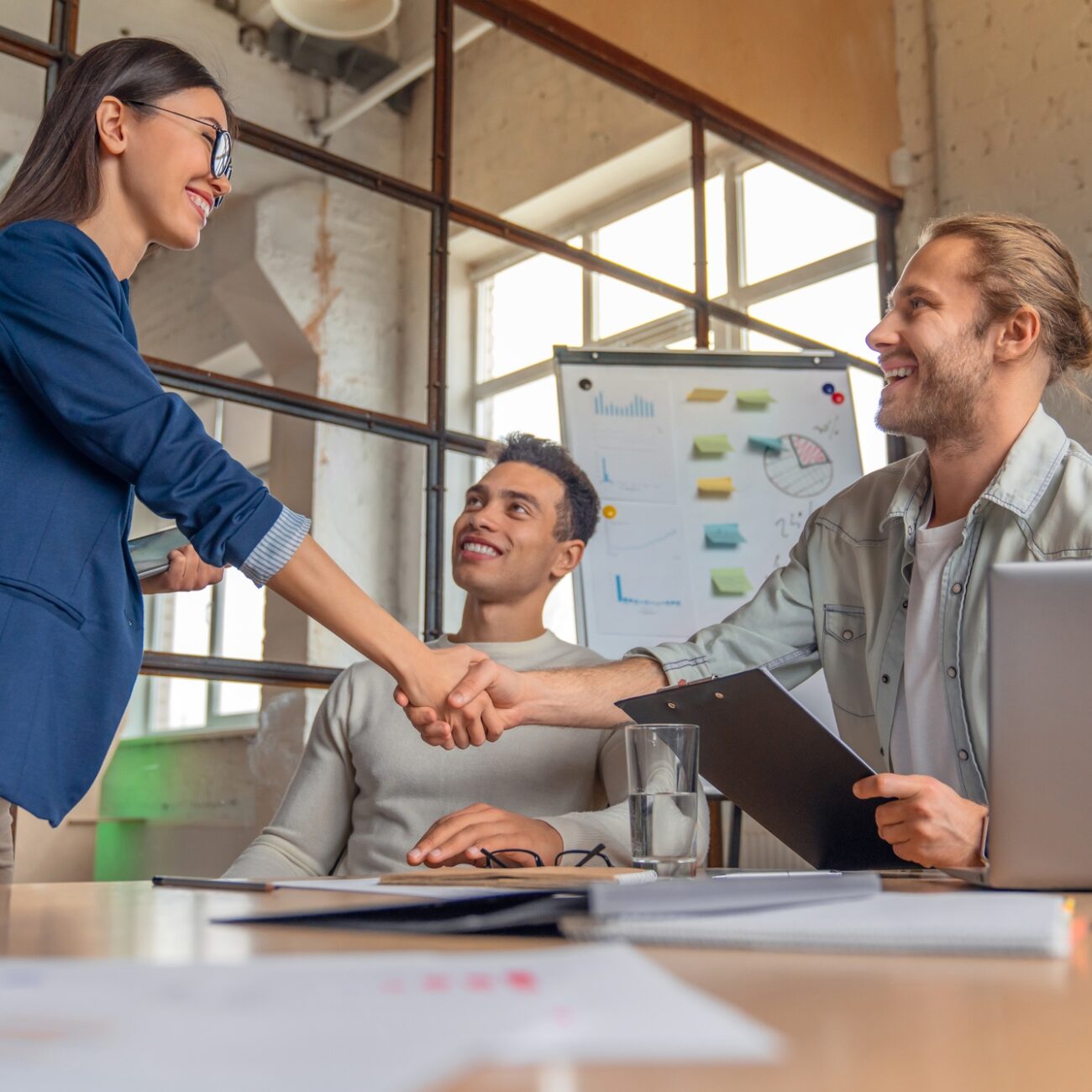 Business people finishing up a meeting. Man shaking hands with female client