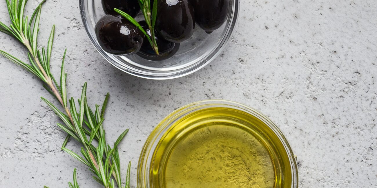 Olive oil, rosemary and olives composition